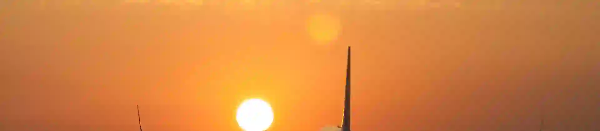 Airplane landing at sunset