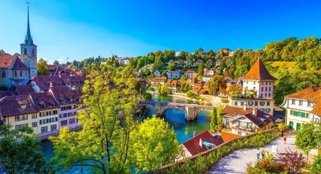 Panoramic view Bern, Switzerland, featuring the historic old town with its medieval buildings and the Aare River flowing through the city