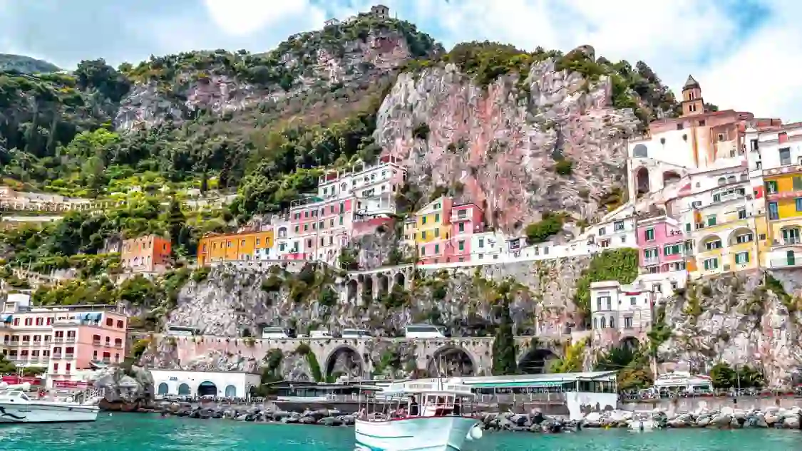 The Amalfi Coast View From Water, showing the buildings along the rock in the cliff