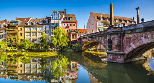 View of Nuremberg river with timber houses on the other side, and a bridge to the right