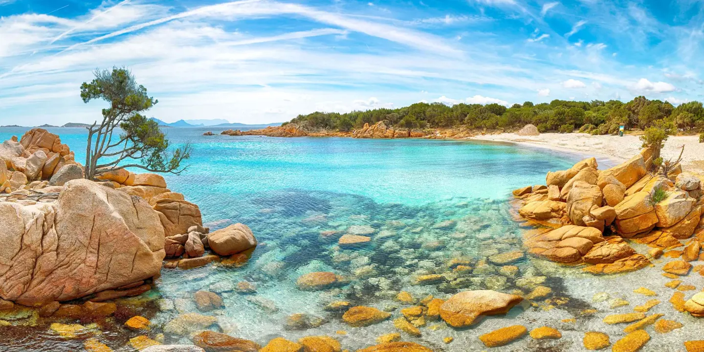 Costa Smeralda seascape, Sardinia, showing the clear blue water and rocks in the forefront