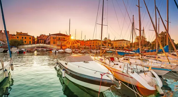 Bardolino Harbour, Lake Garda, Italy, with boats on the water 