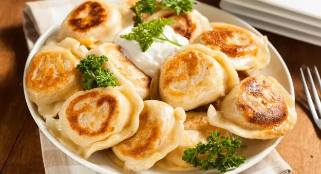 Gettyimages 486978329 Homemade Polish Pierogis With Sour Cream