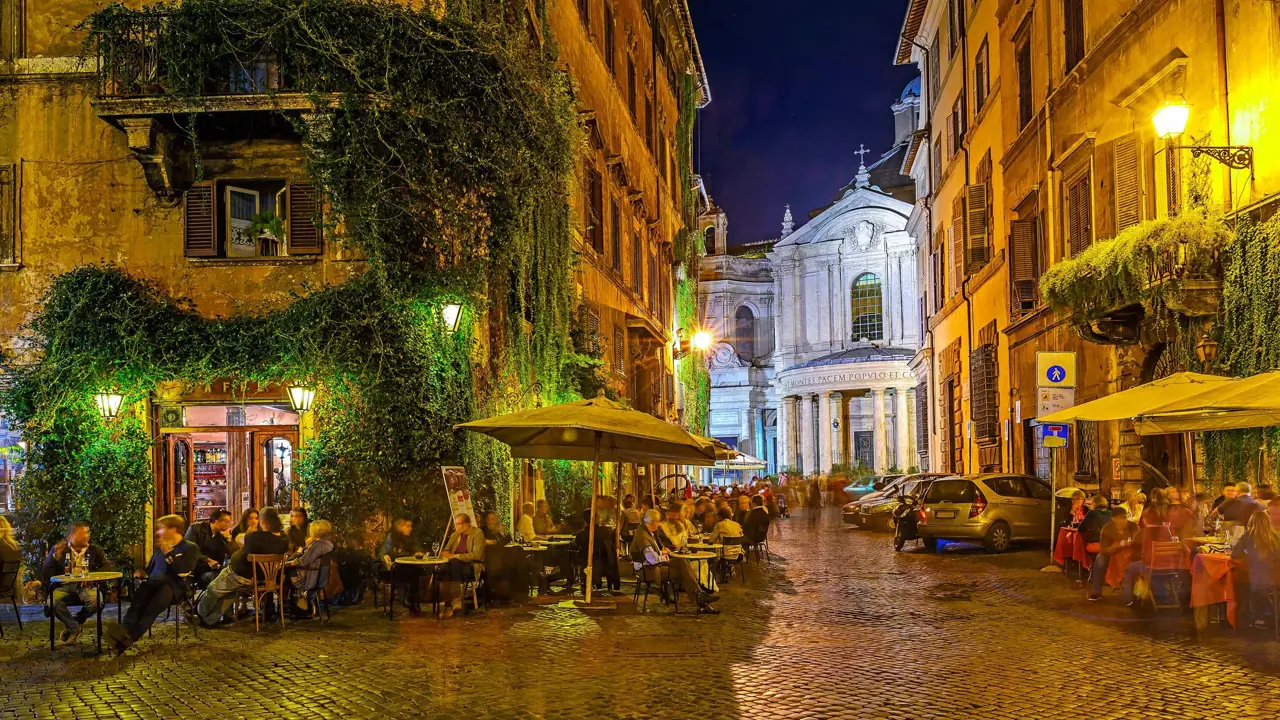 Streets of Rome at night, with people dining al fresco