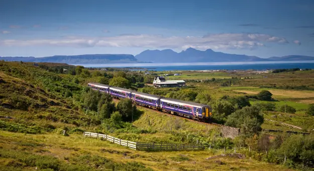 A Sprinter Mallaig Line train going along the railway in the Scottish Highlands