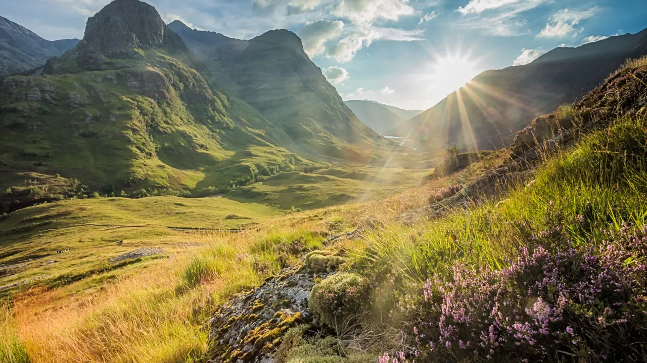 View of the Scottish Highlands with sunshine coming through behind them