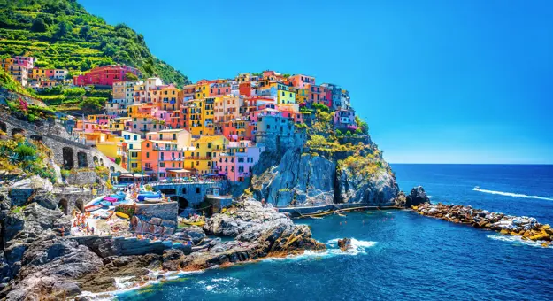 The colourful town of Cinque Terre on a cliff overlooking the sea