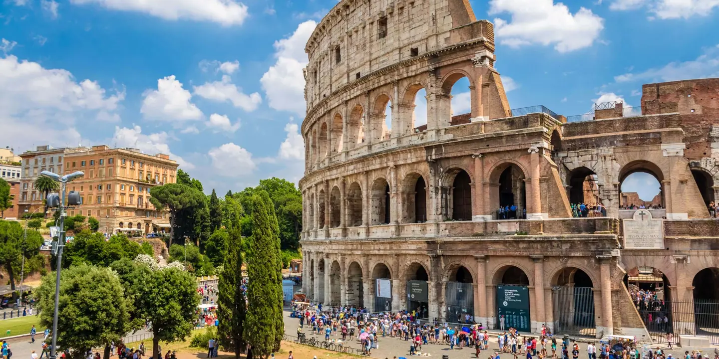 Shot of half the Colosseum and half some of the town in Rome