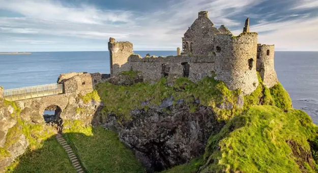 High angle view of a castle on a hill, looking over the sea