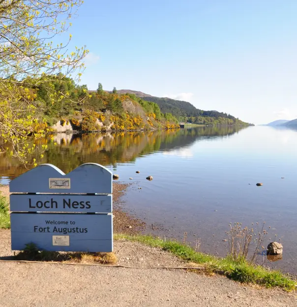  Loch Ness sign in front of the water and mountains 