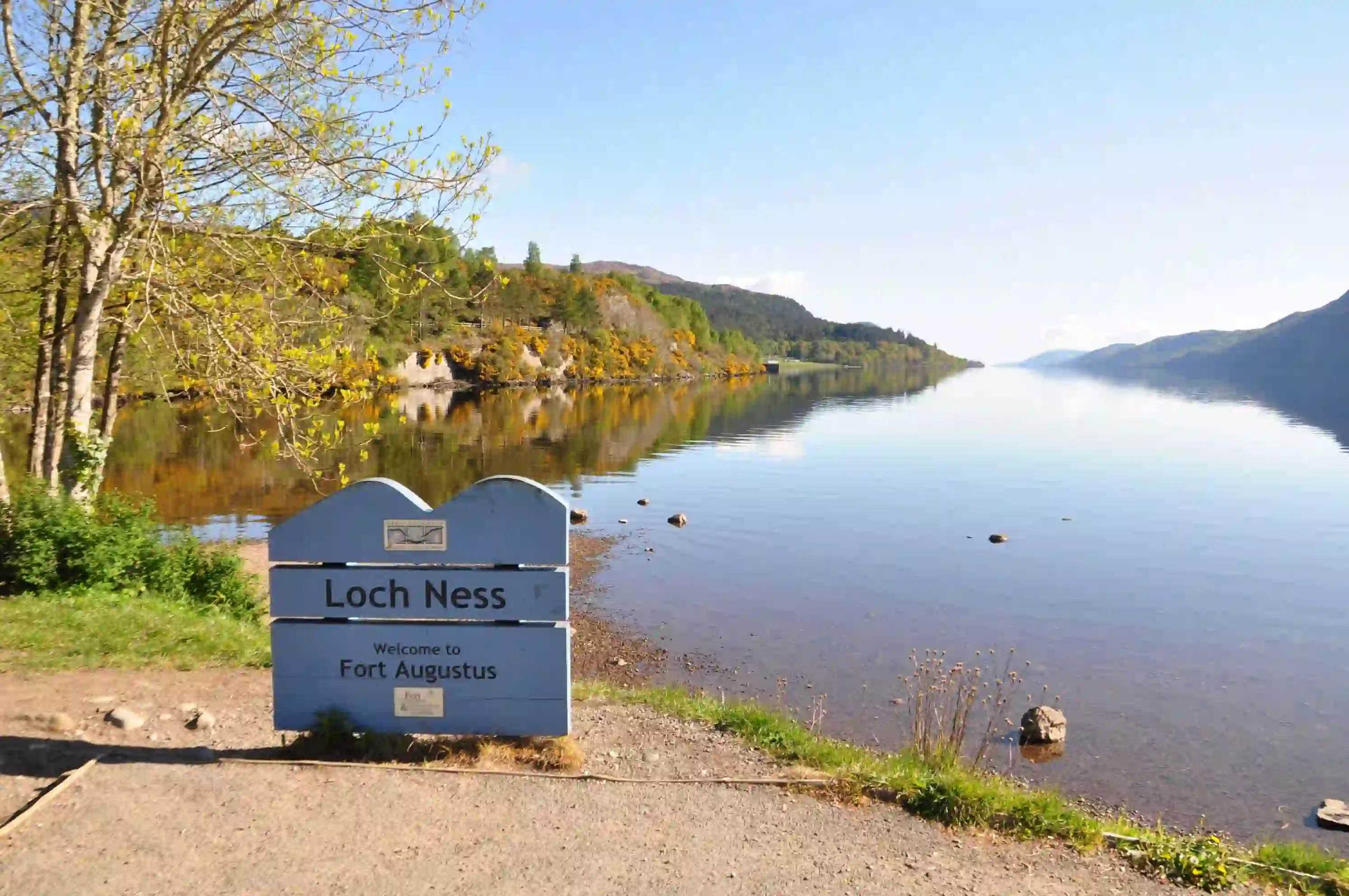  Loch Ness sign in front of the water and mountains 