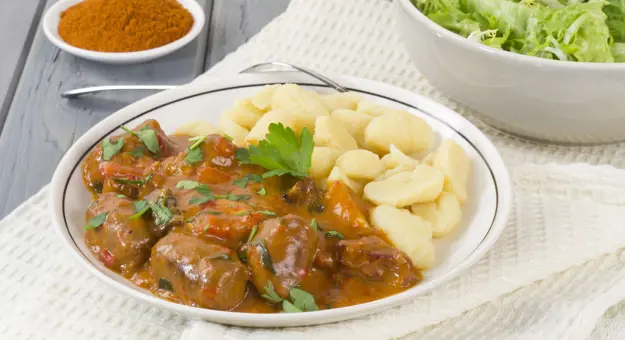 Plate of Pörkölt, a beef an onion stew, with nokedli (dumplings)