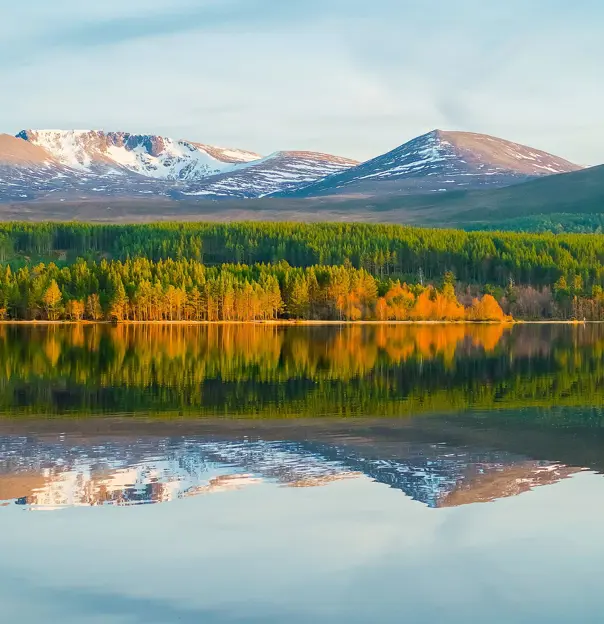 View of Cairngorm Mountains with a loch in the forefront 