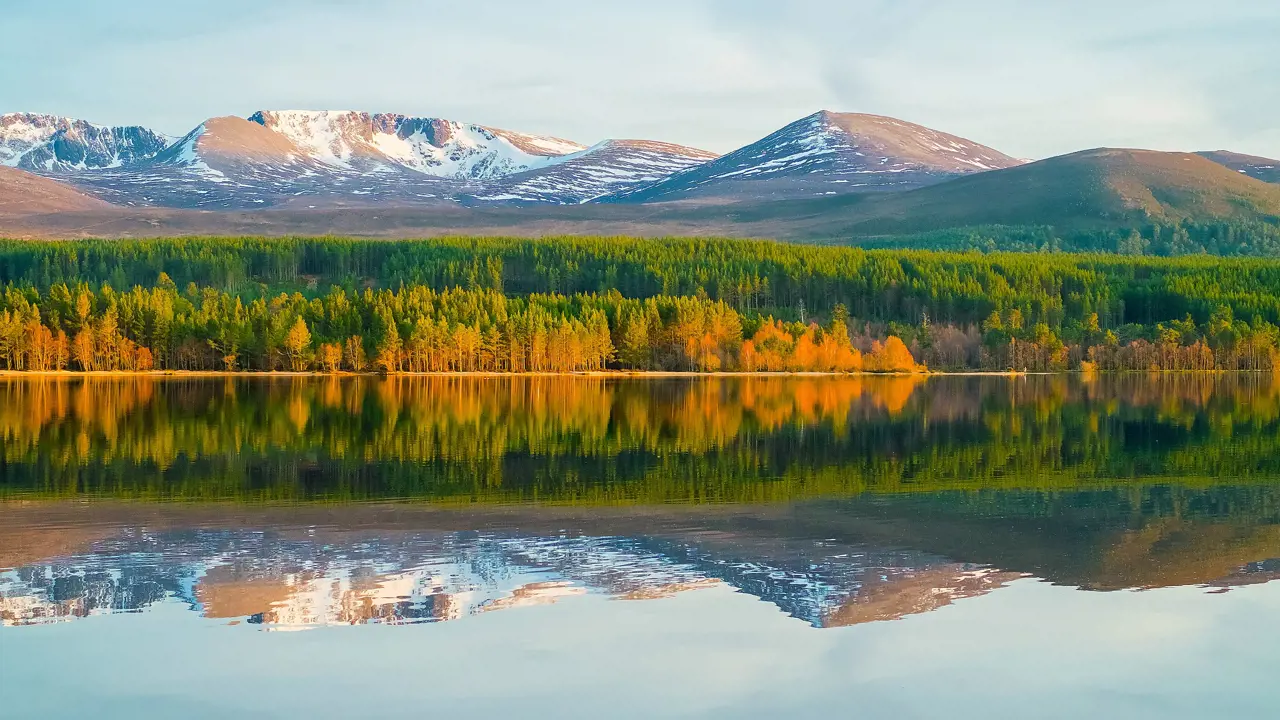 View of Cairngorm Mountains with a loch in the forefront 