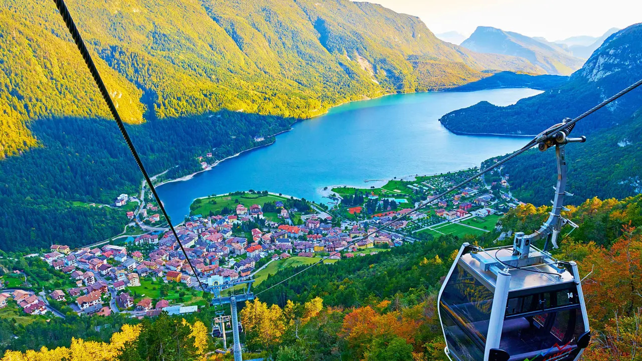 High angle view of Molveno Italy with Lake Molveno and cable car in the forefront