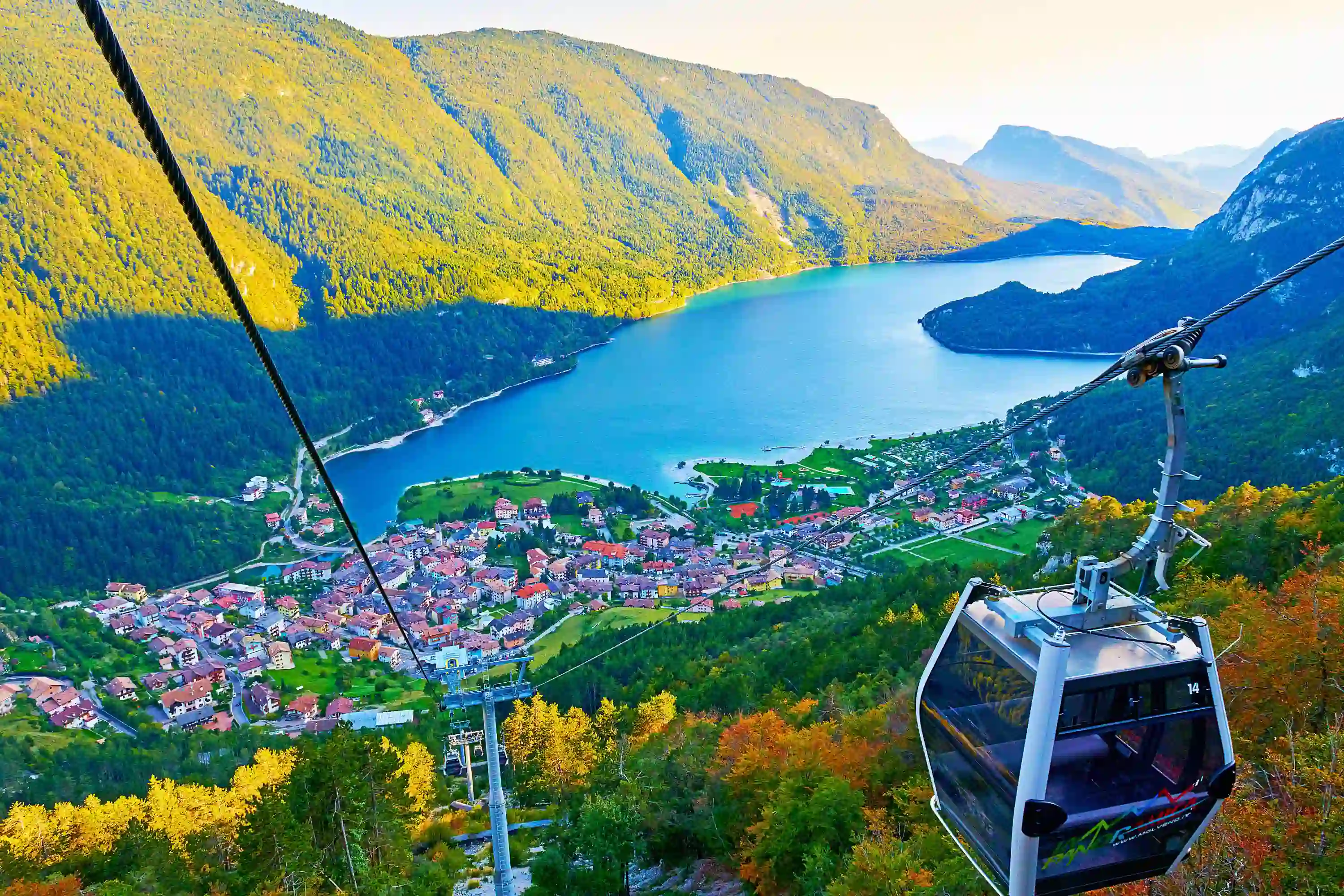 High angle view of Molveno Italy with Lake Molveno and cable car in the forefront