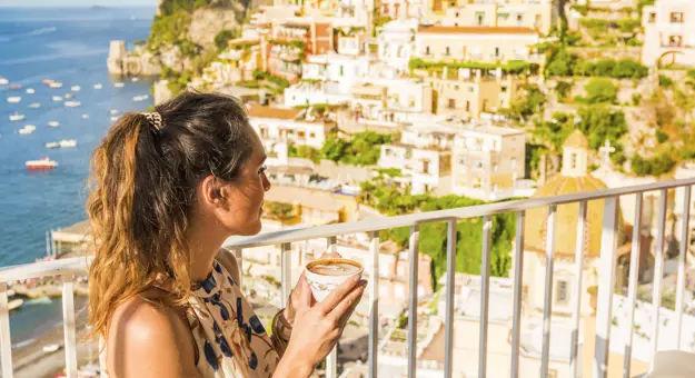 Woman drinking coffee in Positano, Italy