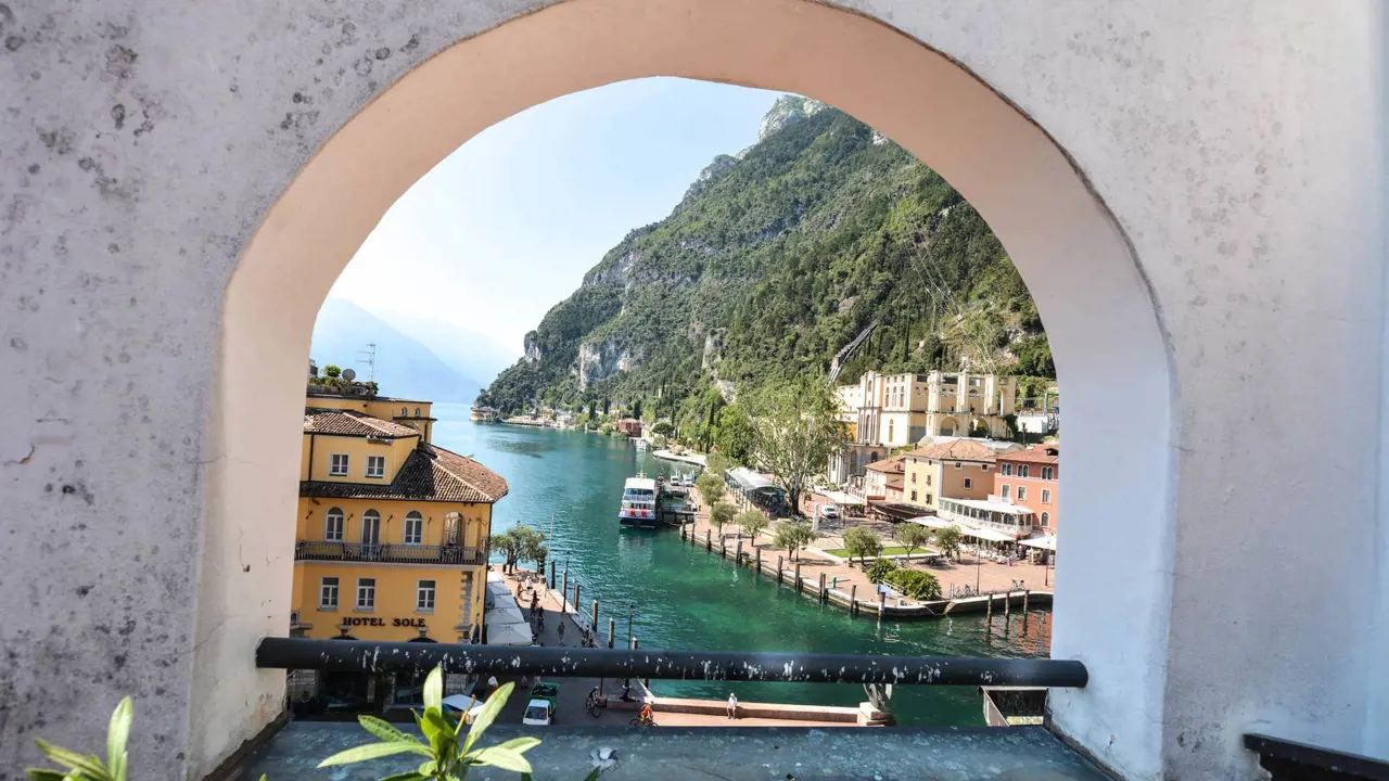 View of Lake Garda through arch-shaped hole in a wall