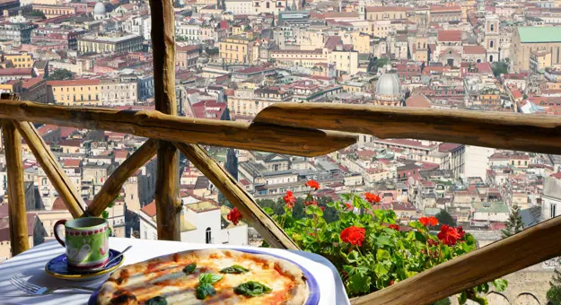 Pizza On Balcony With Naples In Background