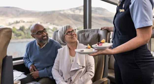 Couple Being Served On Train Through Canadian Rockies