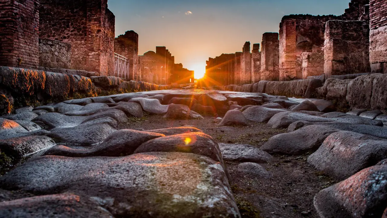 Sunset at Pompeii showing sunbeams shine through the ruins