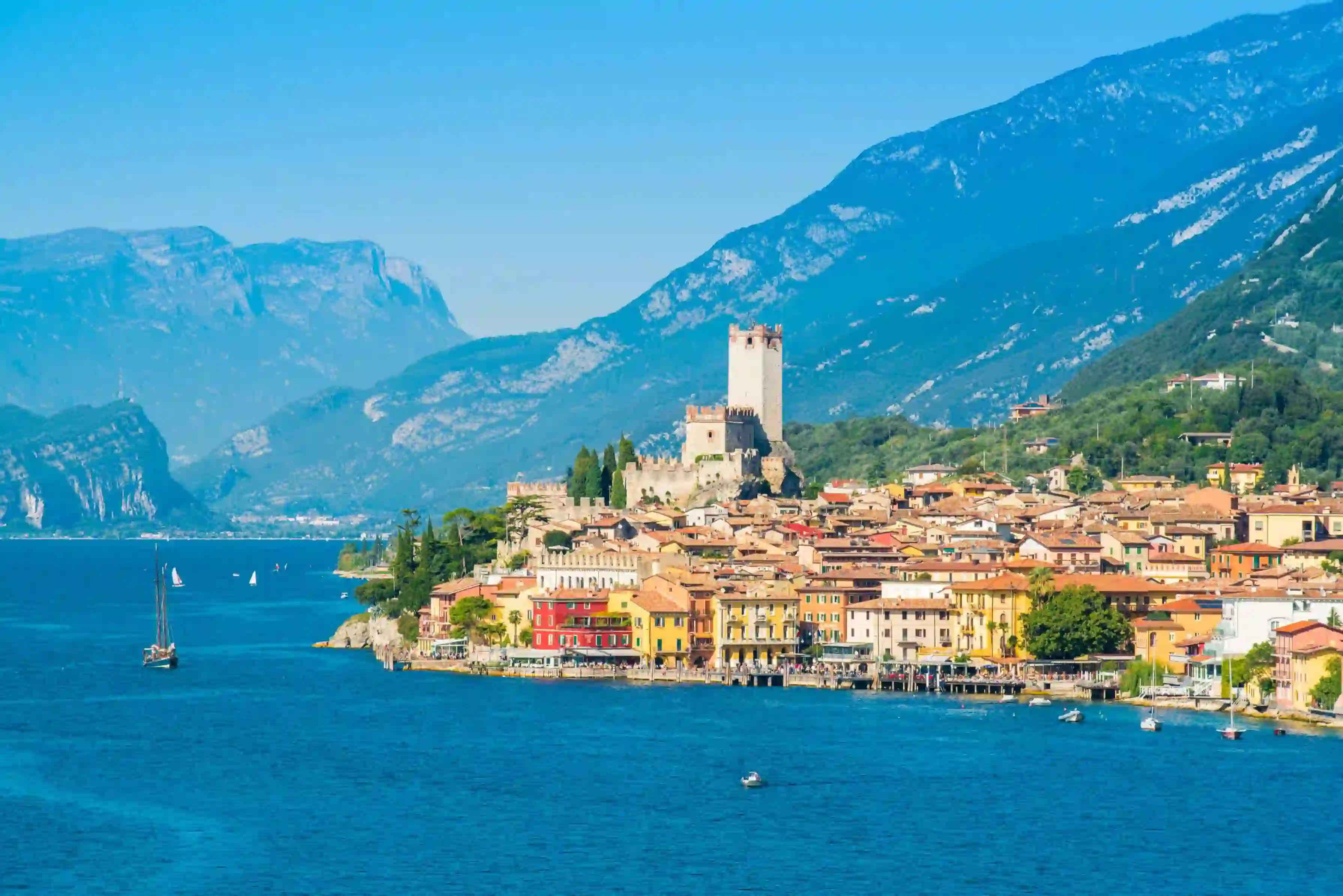 Waterfront in Malcesine, Lake Garda with buildings and mountains in the distance