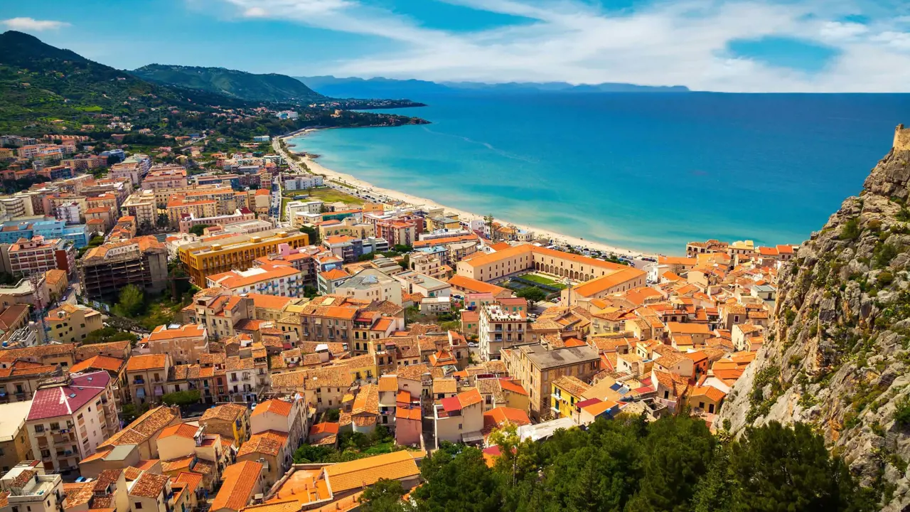 View of the beach and buildings behind it in Cefalu, Sicily, Italy