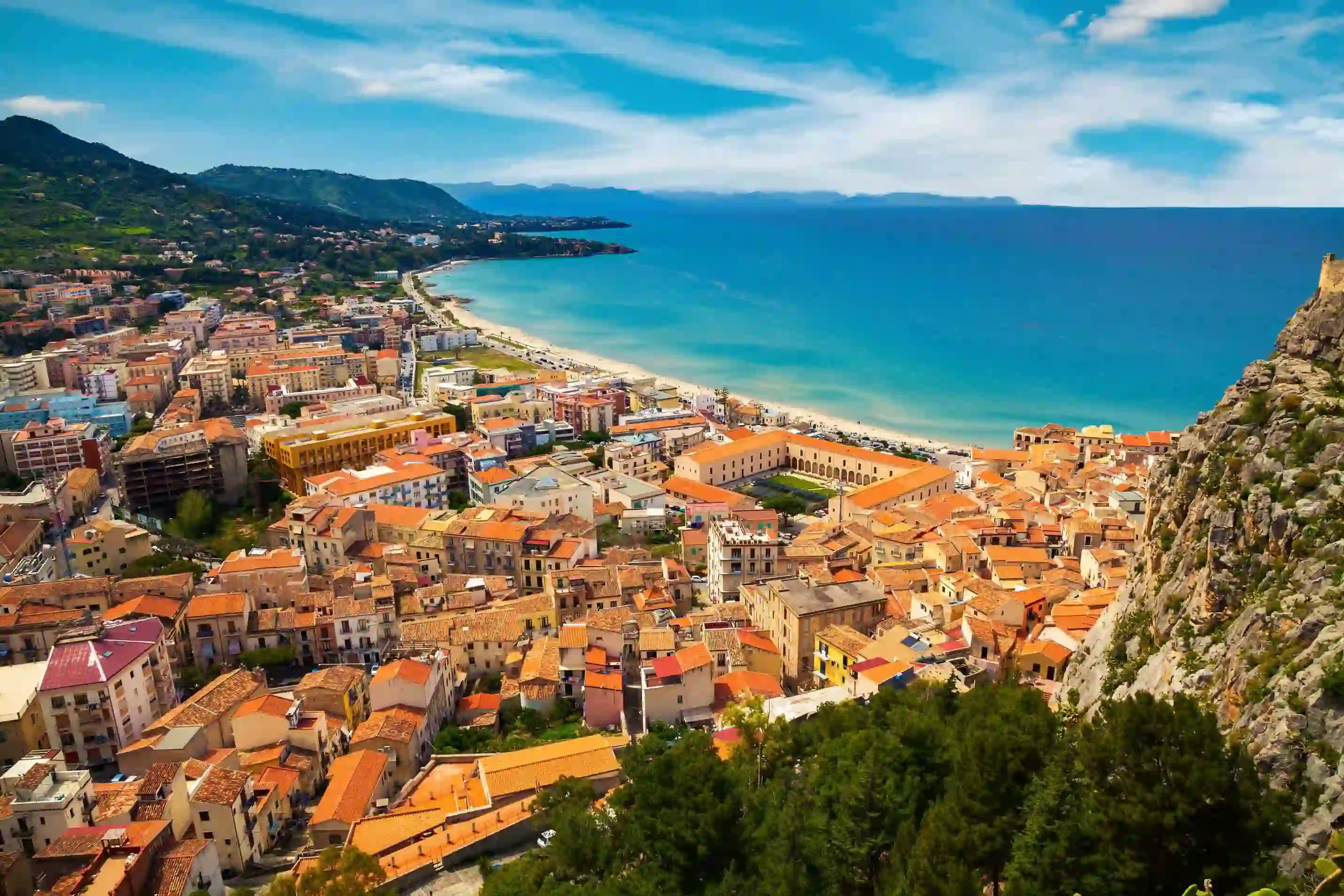 View of the beach and buildings behind it in Cefalu, Sicily, Italy